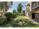 Inviting backyard featuring a lawn, mature trees providing plenty of shade, and a well-maintained exterior of the home at 131 N Higley Rd # 117, Mesa, AZ 85205