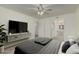Comfortable bedroom with ceiling fan and walk-in closet leading to laundry room at 131 N Higley Rd # 117, Mesa, AZ 85205