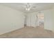 Comfortable bedroom with ceiling fan, closet space, and access to laundry area at 131 N Higley Rd # 117, Mesa, AZ 85205