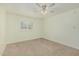 Serene bedroom with neutral walls, carpet flooring, and a window offering natural light at 131 N Higley Rd # 117, Mesa, AZ 85205