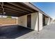 Exterior shot of the covered carport, painted in neutral tones, perfect for protecting vehicles from the elements at 131 N Higley Rd # 117, Mesa, AZ 85205