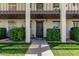 Charming entryway with lush green bushes and shaded walkway leading to the front door of unit 117 at 131 N Higley Rd # 117, Mesa, AZ 85205