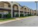 Exterior view of the building featuring balconies, covered walkways and professionally maintained landscaping at 131 N Higley Rd # 117, Mesa, AZ 85205