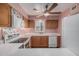 Bright kitchen featuring white countertops, wood cabinetry, and modern appliances at 131 N Higley Rd # 117, Mesa, AZ 85205