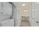 A clean laundry area with a stacked washer and dryer, built-in cabinets and a folding counter at 131 N Higley Rd # 117, Mesa, AZ 85205