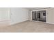 Bright living room featuring neutral carpet, sliding glass doors to patio, and easy access to the kitchen at 131 N Higley Rd # 117, Mesa, AZ 85205