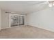 Bright living room with sliding glass doors leading to outdoor space and neutral carpeting at 131 N Higley Rd # 117, Mesa, AZ 85205