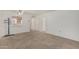 Cozy living area featuring neutral carpeting, open layout, and passthrough to kitchen at 131 N Higley Rd # 117, Mesa, AZ 85205