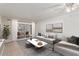 Bright living room with sliding glass doors to patio and neutral decor at 131 N Higley Rd # 117, Mesa, AZ 85205