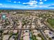 Overhead shot displaying the homes in the neighborhood with solar panels on their roofs and the nearby golf course at 13857 W Windsor Ave, Goodyear, AZ 85395