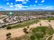 Aerial view of property near lush golf course offering scenic views and recreational opportunities, with nearby homes and beautiful blue skies at 13857 W Windsor Ave, Goodyear, AZ 85395
