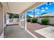 Covered back patio with stone landscaping and lush greenery at 13857 W Windsor Ave, Goodyear, AZ 85395