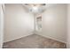 Simple bedroom with neutral carpet, a ceiling fan, and a window offering natural light at 13857 W Windsor Ave, Goodyear, AZ 85395