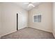 Bright bedroom with neutral carpet, ceiling fan and a window providing natural light at 13857 W Windsor Ave, Goodyear, AZ 85395