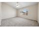 Spacious bedroom with neutral carpet, ceiling fan, and window offering ample natural light at 13857 W Windsor Ave, Goodyear, AZ 85395