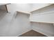 Walk-in closet with carpeted floor, white walls, and multiple wooden hanging rods at 13857 W Windsor Ave, Goodyear, AZ 85395