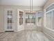 Dining area with tile floors, large windows, and plenty of natural light at 13857 W Windsor Ave, Goodyear, AZ 85395