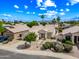 A beautiful single-story home with desert landscaping, a two-car garage, and a tile roof is bathed in sunshine at 13857 W Windsor Ave, Goodyear, AZ 85395