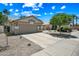 Single-story home with desert landscaping and a spacious driveway leading to the garage at 13857 W Windsor Ave, Goodyear, AZ 85395