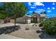 A charming single-story house is presented with well-maintained desert landscaping and a two-car garage at 13857 W Windsor Ave, Goodyear, AZ 85395