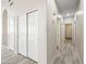 Bright hallway with tiled floors and closet storage, leading to other rooms in the home at 13857 W Windsor Ave, Goodyear, AZ 85395