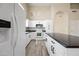 Updated kitchen featuring white cabinets, granite countertops, and stainless steel appliances at 13857 W Windsor Ave, Goodyear, AZ 85395