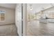 Open-concept living and kitchen area boasts light-filled windows, tiled floors, and white cabinetry at 13857 W Windsor Ave, Goodyear, AZ 85395