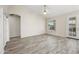 Spacious living room with tile floors, ceiling fan, and natural light from the window at 13857 W Windsor Ave, Goodyear, AZ 85395