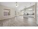 Open-concept living room and kitchen area with tile flooring, high ceilings, and plenty of natural light at 13857 W Windsor Ave, Goodyear, AZ 85395