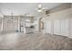 Bright and airy living room with open layout and kitchen featuring white cabinets and breakfast bar at 13857 W Windsor Ave, Goodyear, AZ 85395
