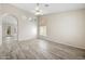 Inviting living room features stylish plank flooring, neutral paint, and abundant natural light at 13857 W Windsor Ave, Goodyear, AZ 85395
