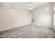 This bright living area features plank flooring, neutral paint, transom windows, and an open floor plan at 13857 W Windsor Ave, Goodyear, AZ 85395