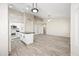 Open-concept kitchen and living area with tile flooring, recessed lighting, and white cabinets at 13857 W Windsor Ave, Goodyear, AZ 85395