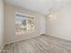 Bright living room features plank flooring, neutral walls, and a large window, creating a comfortable space at 13857 W Windsor Ave, Goodyear, AZ 85395