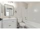 Bright bathroom with modern mirror over sink, white cabinets and shower over white tub at 1416 W Highland St, Chandler, AZ 85224