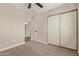 Bedroom featuring a sliding door closet and neutral carpet at 1416 W Highland St, Chandler, AZ 85224