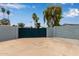 Secure driveway gate leading to ample parking, surrounded by a block wall and a few trees at 1416 W Highland St, Chandler, AZ 85224