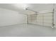 Clean, epoxy-floored garage with a paneled roll-up door and painted cinder block walls at 1416 W Highland St, Chandler, AZ 85224
