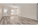 Bright and spacious living room featuring modern wood-look floors and ample natural light at 1416 W Highland St, Chandler, AZ 85224