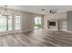 Cozy living room with fireplace, ceiling fan, and sliding glass doors to the pool area at 1416 W Highland St, Chandler, AZ 85224