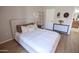 Light-filled bedroom features wood flooring, neutral decor, and access to the primary bathroom at 14250 W Wigwam Blvd # 522, Litchfield Park, AZ 85340