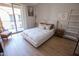 Bright bedroom with wood flooring, large slider to balcony and neutral decor at 14250 W Wigwam Blvd # 522, Litchfield Park, AZ 85340