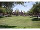Expansive lawn area with mature trees and walking path within the community at 14250 W Wigwam Blvd # 522, Litchfield Park, AZ 85340
