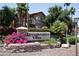 Renaissance Villas community sign with lush landscaping and a view of the multi-story building with stone accents at 14250 W Wigwam Blvd # 522, Litchfield Park, AZ 85340