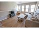 Inviting living room featuring neutral tones, wood-look floors, a comfortable sectional, and bright natural lighting at 14250 W Wigwam Blvd # 522, Litchfield Park, AZ 85340