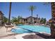 Sparkling community pool with adjacent spa, surrounded by mature landscaping at 14250 W Wigwam Blvd # 522, Litchfield Park, AZ 85340