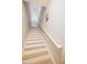 Bright staircase featuring neutral walls, light wood steps, and a white handrail leading upstairs at 14250 W Wigwam Blvd # 522, Litchfield Park, AZ 85340