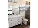 Modern bathroom features a double sink vanity, open shelving, and glass shower with pebble floor at 1469 S Boulder St # C, Gilbert, AZ 85296