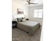Bright bedroom with ceiling fan, landscape art, bedside lamps and window with blinds at 1469 S Boulder St # C, Gilbert, AZ 85296