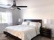Bedroom with dark wood bed frame, patterned bedding, and bedside lamps at 1469 S Boulder St # C, Gilbert, AZ 85296